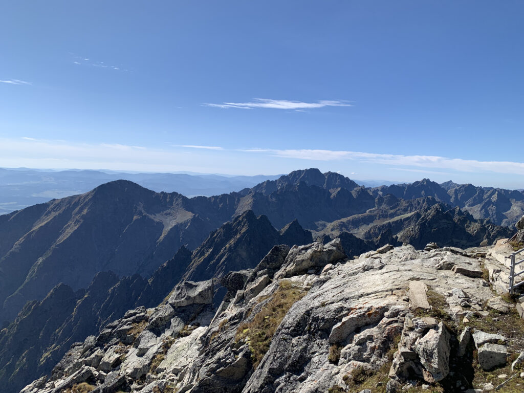 Rocky mountain ridge in the High Tatras with dramatic peaks stretching into the distance under a bright blue sky